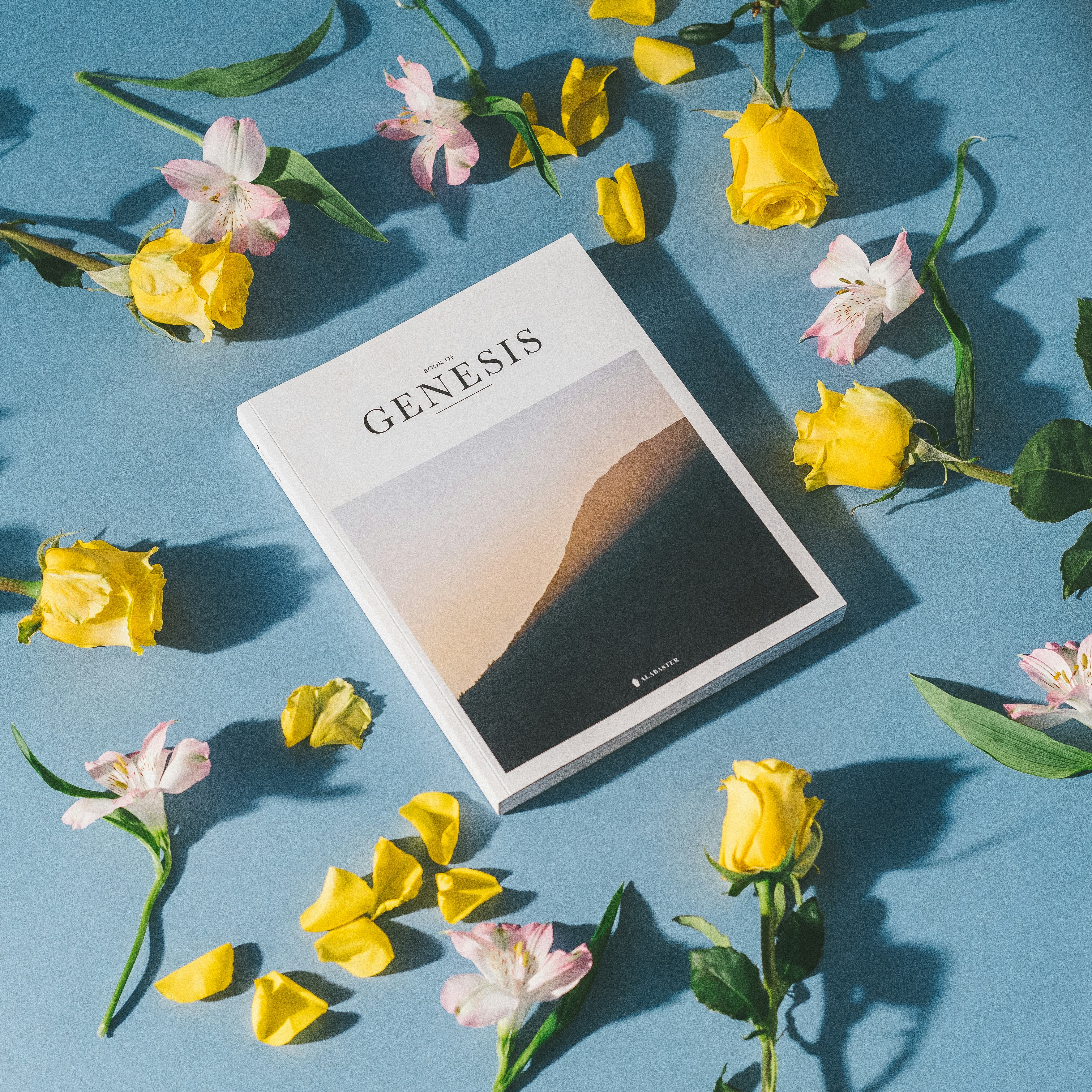 Genesis book surrounded by flowers